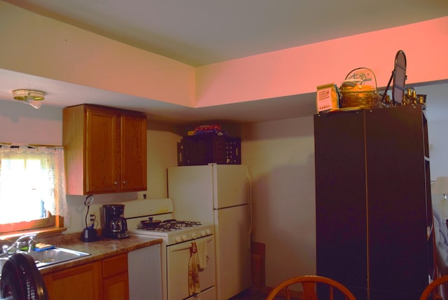 1467 N Black River Rd, Cheboygan, MI 49721 - kitchen featuring white appliances, brown cabinetry, and a sink
