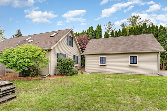 5313 S Pine St, Beaverton, MI 48612 - back of property with a lawn and roof with shingles
