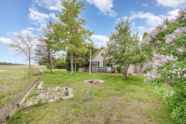 5313 S Pine St, Beaverton, MI 48612 - view of yard featuring a fire pit and a wooden deck