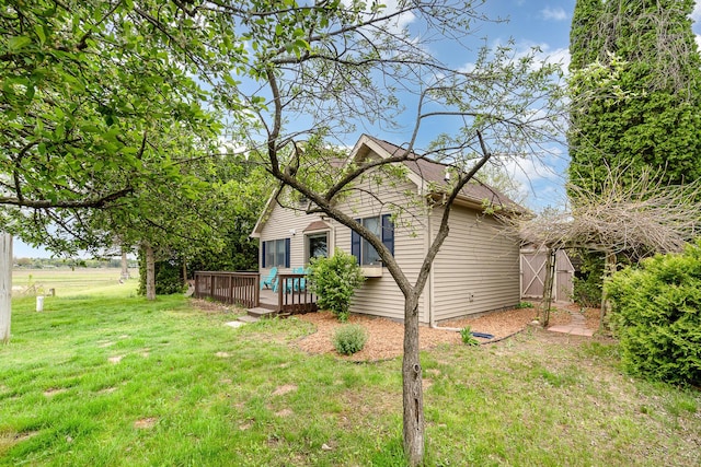 5313 S Pine St, Beaverton, MI 48612 - view of home's exterior featuring a deck and a lawn