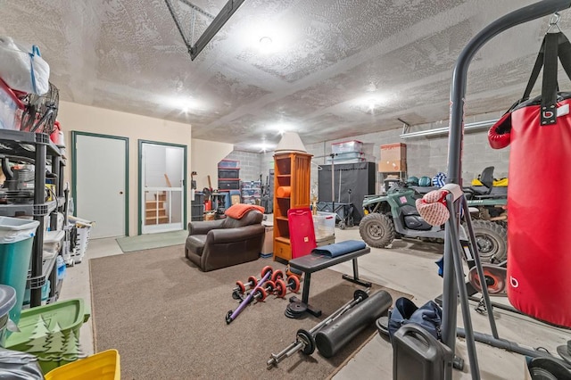 6122 Beach Rd, Johannesburg, MI 49751 - workout room featuring concrete block wall and a textured ceiling