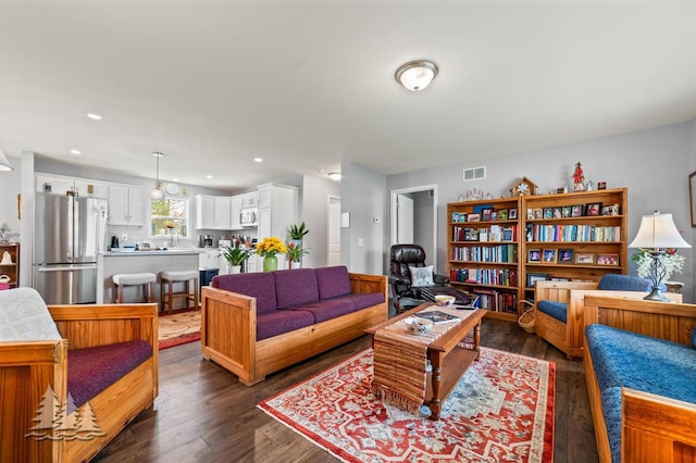3211 Jenson St, Lewiston, MI 49756 - living room with dark wood-style floors, visible vents, and recessed lighting