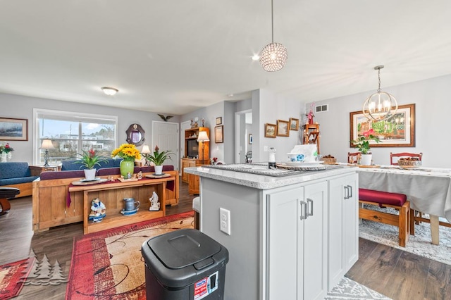 3211 Jenson St, Lewiston, MI 49756 - kitchen with open floor plan, a chandelier, dark wood-style floors, pendant lighting, and visible vents