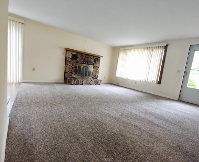 638 Old Trail Dr, Houghton Lake, MI 48629 - unfurnished living room featuring carpet flooring, a fireplace, and baseboards