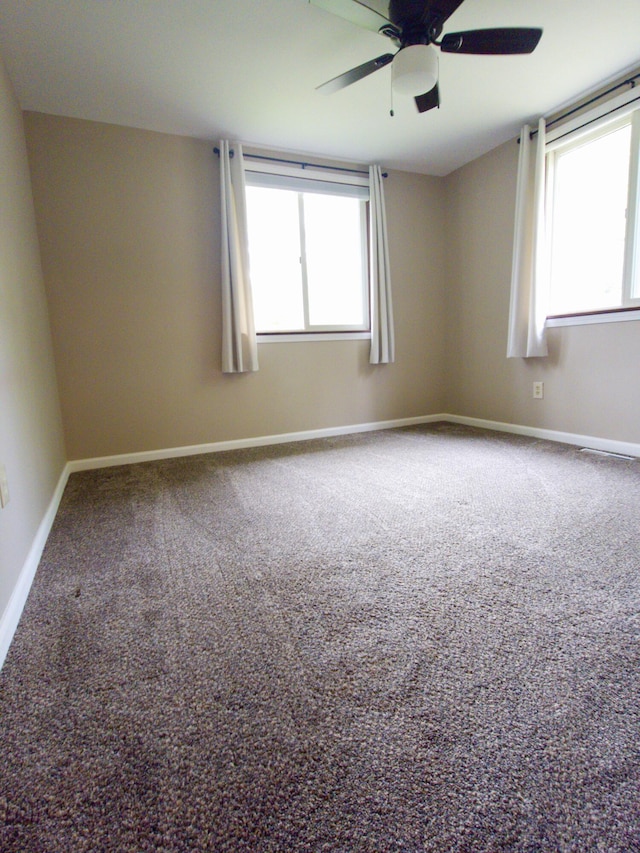 638 Old Trail Dr, Houghton Lake, MI 48629 - unfurnished room featuring carpet, a ceiling fan, and baseboards