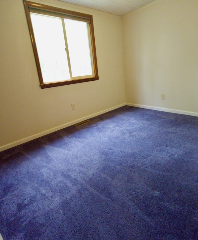 638 Old Trail Dr, Houghton Lake, MI 48629 - unfurnished room with baseboards and dark colored carpet