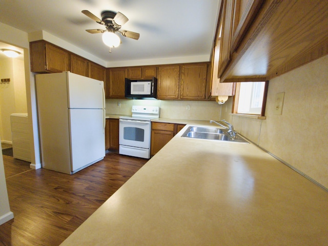 638 Old Trail Dr, Houghton Lake, MI 48629 - kitchen with white appliances, a sink, a ceiling fan, dark wood finished floors, and light countertops