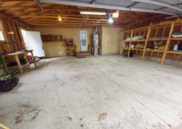 638 Old Trail Dr, Houghton Lake, MI 48629 - garage featuring a garage door opener and water heater