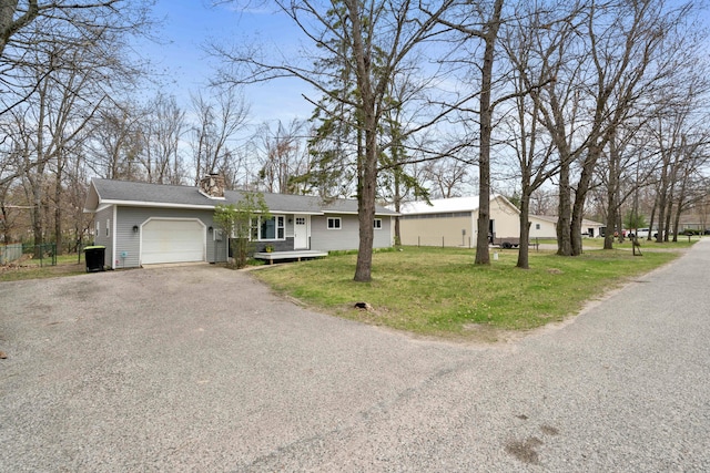 6830 Elmwood, Indian River, MI 49749 - view of front of property with an attached garage, a chimney, and driveway
