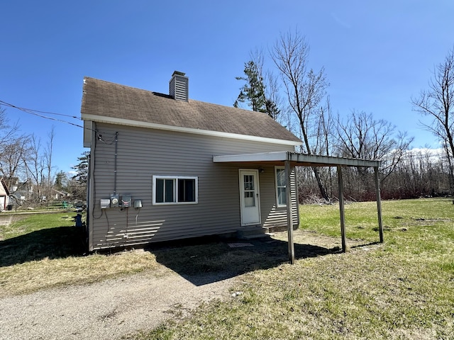 1117 Mackinaw Ave, Cheboygan, MI 49721 - bungalow-style home featuring a front lawn, roof with shingles, a chimney, and entry steps