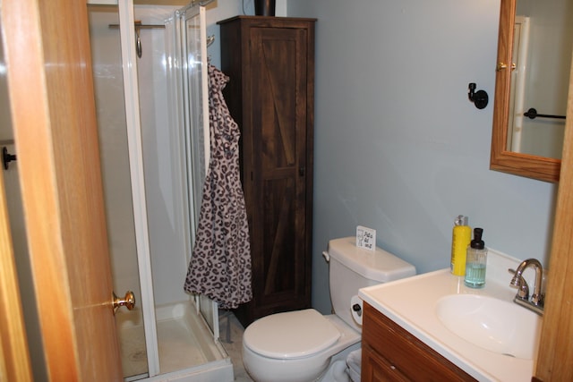full bath featuring a shower stall, toilet, and vanity