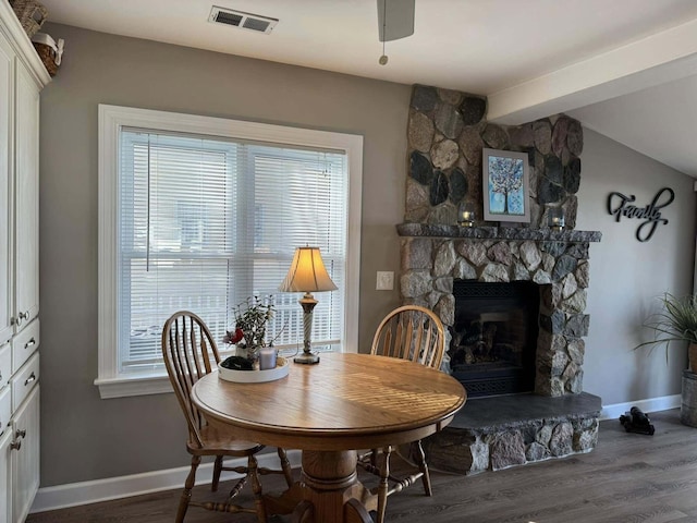 605 Sam-O-Set Blvd, Roscommon, MI 48653 - dining space with baseboards, dark wood-style floors, visible vents, vaulted ceiling with beams, and a fireplace