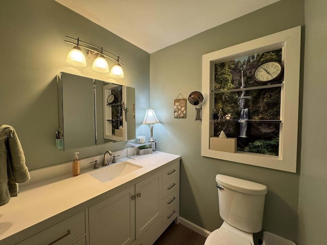 605 Sam-O-Set Blvd, Roscommon, MI 48653 - bathroom featuring baseboards, toilet, and vanity