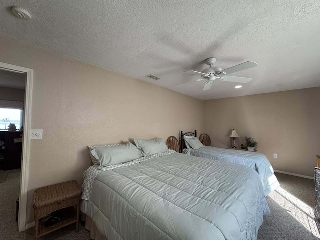 605 Sam-O-Set Blvd, Roscommon, MI 48653 - bedroom featuring a ceiling fan, a textured ceiling, baseboards, visible vents, and carpet