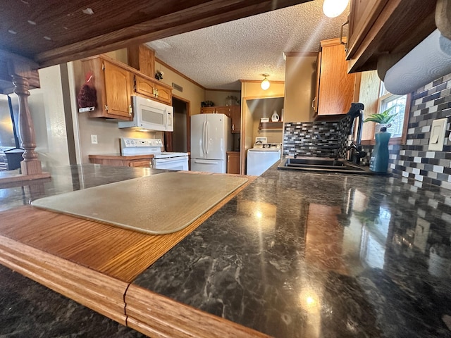 5128 Krys Rd, Gaylord, MI 49735 - kitchen featuring ornamental molding, washer / dryer, white appliances, tasteful backsplash, and a sink