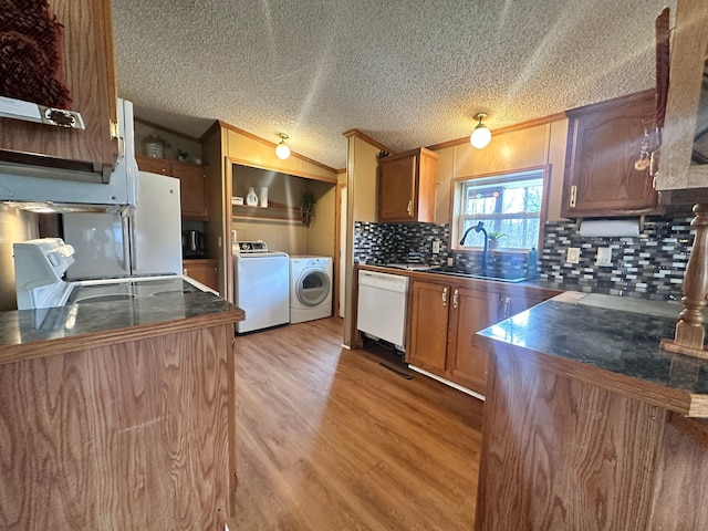 5128 Krys Rd, Gaylord, MI 49735 - kitchen with decorative backsplash, dishwasher, a sink, separate washer and dryer, and ornamental molding