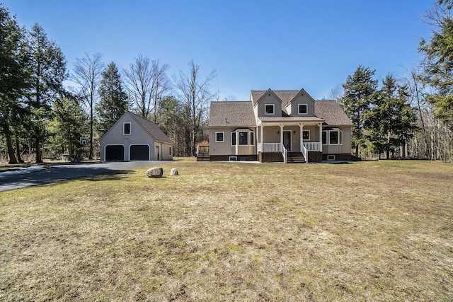 cape cod house with a detached garage, an outbuilding, a front yard, and covered porch