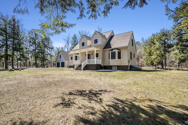 rear view of property featuring a lawn and a porch