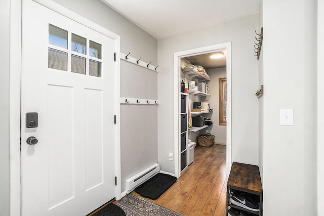 mudroom with baseboard heating, baseboards, and light wood-style flooring