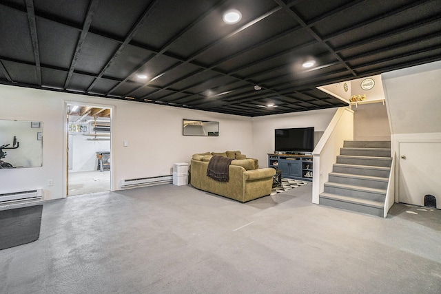 living room featuring a baseboard radiator, stairway, and concrete floors