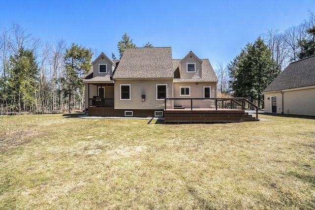 back of property featuring a lawn and a wooden deck