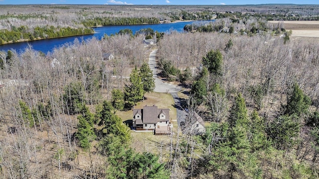 drone / aerial view featuring a view of trees and a water view