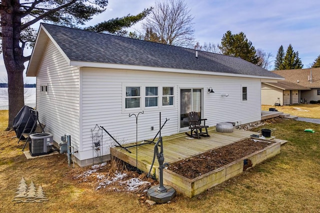 4565 Grant Dr, Lewiston, MI 49756 - back of house featuring central AC unit, roof with shingles, a yard, and a deck