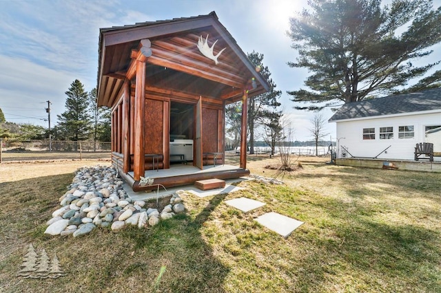 4565 Grant Dr, Lewiston, MI 49756 - exterior space featuring an outdoor structure and fence