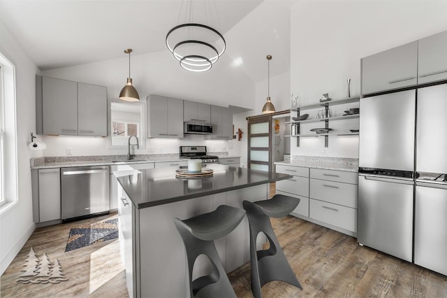4565 Grant Dr, Lewiston, MI 49756 - kitchen with open shelves, appliances with stainless steel finishes, gray cabinetry, and a sink