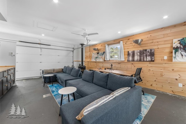 4565 Grant Dr, Lewiston, MI 49756 - living room with concrete floors, wood walls, attic access, and recessed lighting