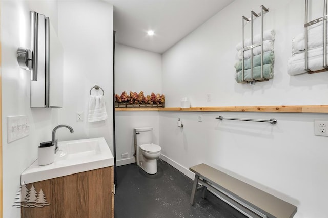4565 Grant Dr, Lewiston, MI 49756 - bathroom featuring concrete flooring, vanity, baseboards, toilet, and recessed lighting