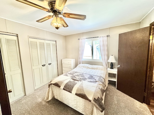 1570 E College Dr, Lewiston, MI 49756 - carpeted bedroom featuring two closets, crown molding, and a ceiling fan