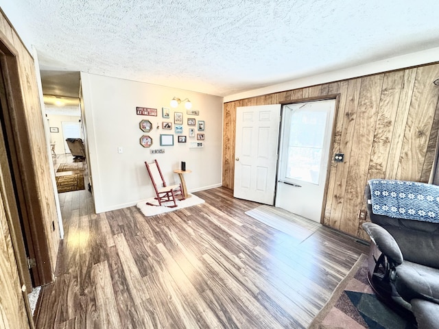 1570 E College Dr, Lewiston, MI 49756 - living area featuring a textured ceiling and wood finished floors