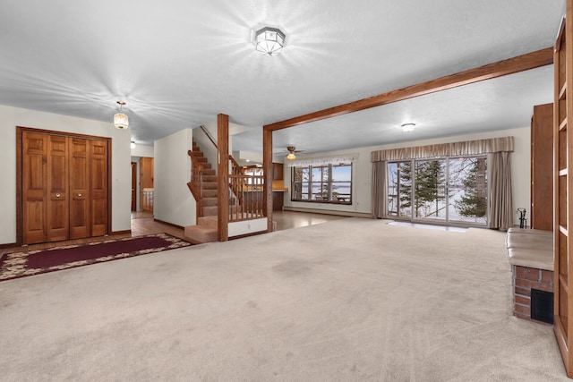 1384 W Higgins Lake Dr, Roscommon, MI 48653 - unfurnished living room with stairway, carpet flooring, a ceiling fan, beam ceiling, and baseboards