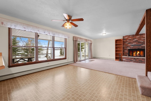1384 W Higgins Lake Dr, Roscommon, MI 48653 - unfurnished living room with a baseboard radiator, a ceiling fan, baseboards, and a brick fireplace