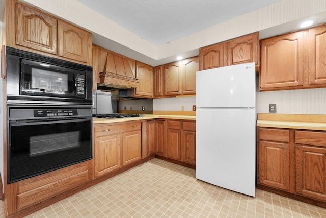 1384 W Higgins Lake Dr, Roscommon, MI 48653 - kitchen with black appliances, light countertops, custom range hood, light flooring, and brown cabinetry