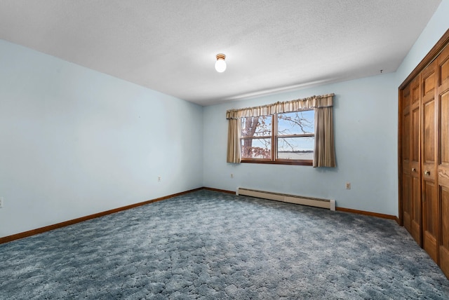 1384 W Higgins Lake Dr, Roscommon, MI 48653 - unfurnished bedroom with baseboard heating, carpet, baseboards, a closet, and a textured ceiling