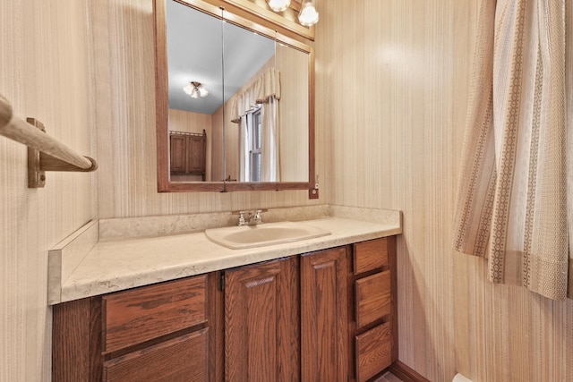 1384 W Higgins Lake Dr, Roscommon, MI 48653 - bathroom with wallpapered walls and vanity