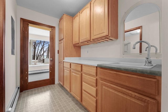 1384 W Higgins Lake Dr, Roscommon, MI 48653 - kitchen featuring a baseboard radiator, a sink, and light brown cabinetry
