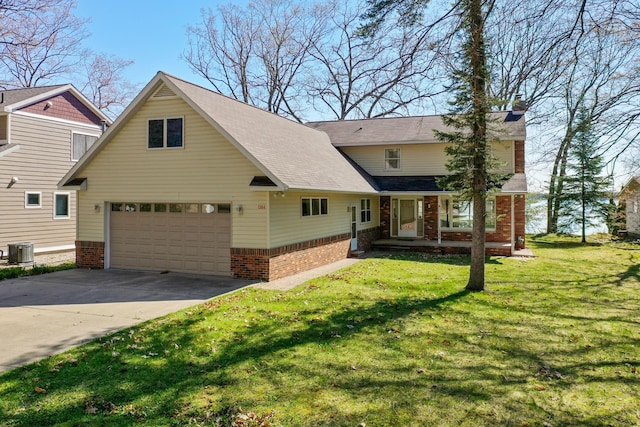 1384 W Higgins Lake Dr, Roscommon, MI 48653 - view of front of house with cooling unit, brick siding, a front lawn, an attached garage, and concrete driveway