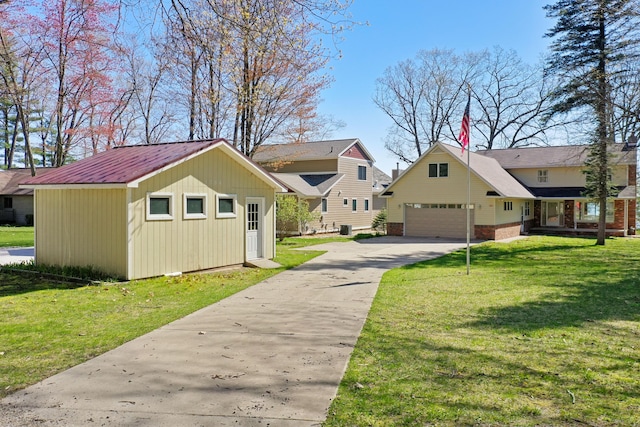 1384 W Higgins Lake Dr, Roscommon, MI 48653 - view of front of house featuring a garage, a front yard, driveway, and an outbuilding