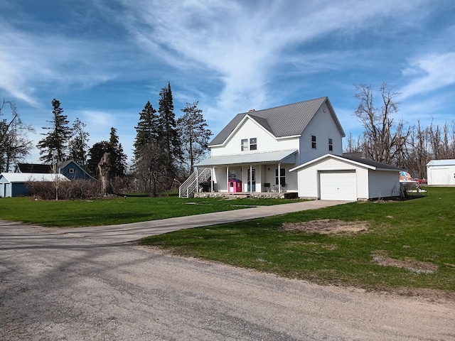 2960 Birch St, Johannesburg, MI 49751 - view of front of property featuring an attached garage, a porch, a front yard, concrete driveway, and metal roof