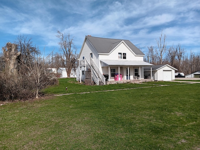 2960 Birch St, Johannesburg, MI 49751 - view of front of house with covered porch, metal roof, a front yard, stairway, and an attached garage
