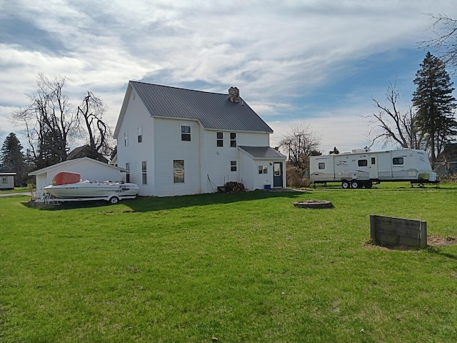 2960 Birch St, Johannesburg, MI 49751 - rear view of property with a lawn, a chimney, and metal roof