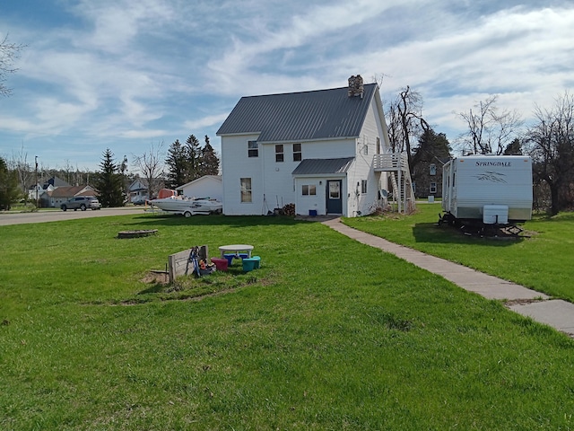 2960 Birch St, Johannesburg, MI 49751 - exterior space with a lawn, a chimney, and metal roof