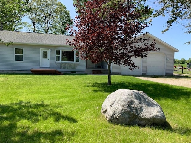 view of front of property with a garage and a front yard