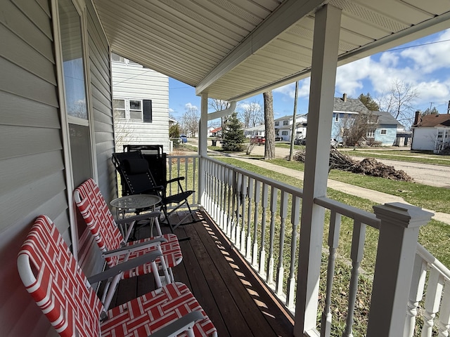 wooden deck with covered porch and a residential view