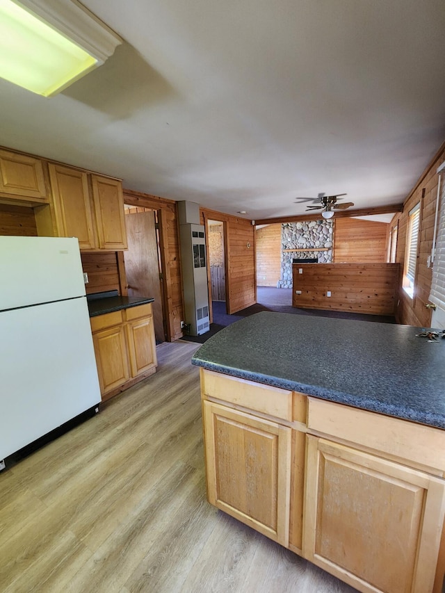 11359 Polaris St, Saint Helen, MI 48656 - kitchen featuring freestanding refrigerator, wooden walls, a ceiling fan, light wood finished floors, and dark countertops