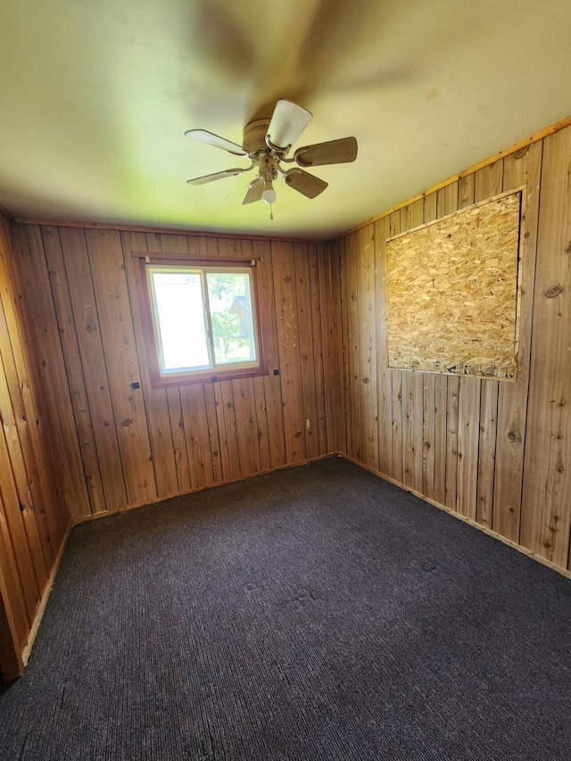 11359 Polaris St, Saint Helen, MI 48656 - carpeted spare room featuring a ceiling fan and wood walls