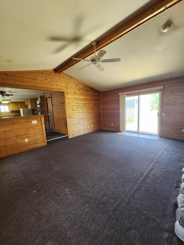 11359 Polaris St, Saint Helen, MI 48656 - unfurnished living room with ceiling fan, wood walls, and dark colored carpet